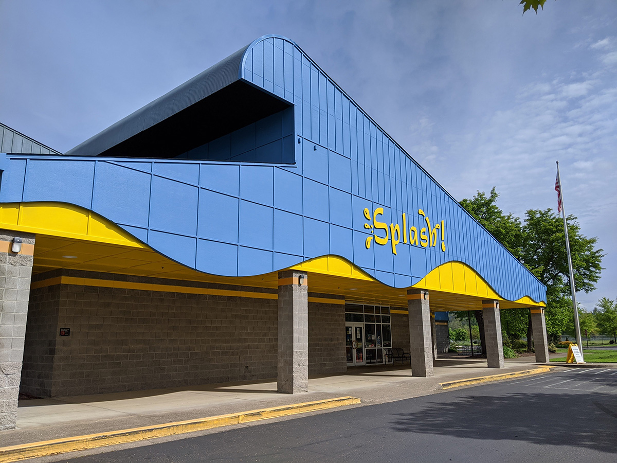 Blue and yellow exterior building of Splash! on a sunny day