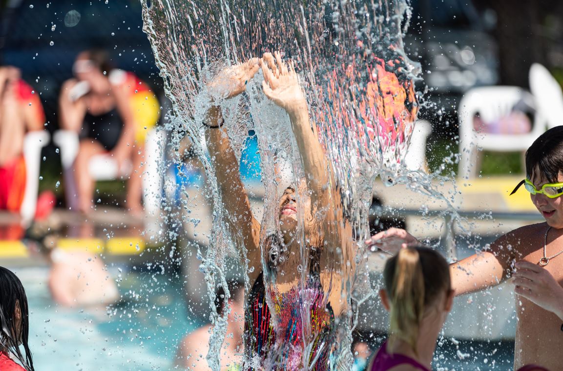 Child at waterpark playing in water. 