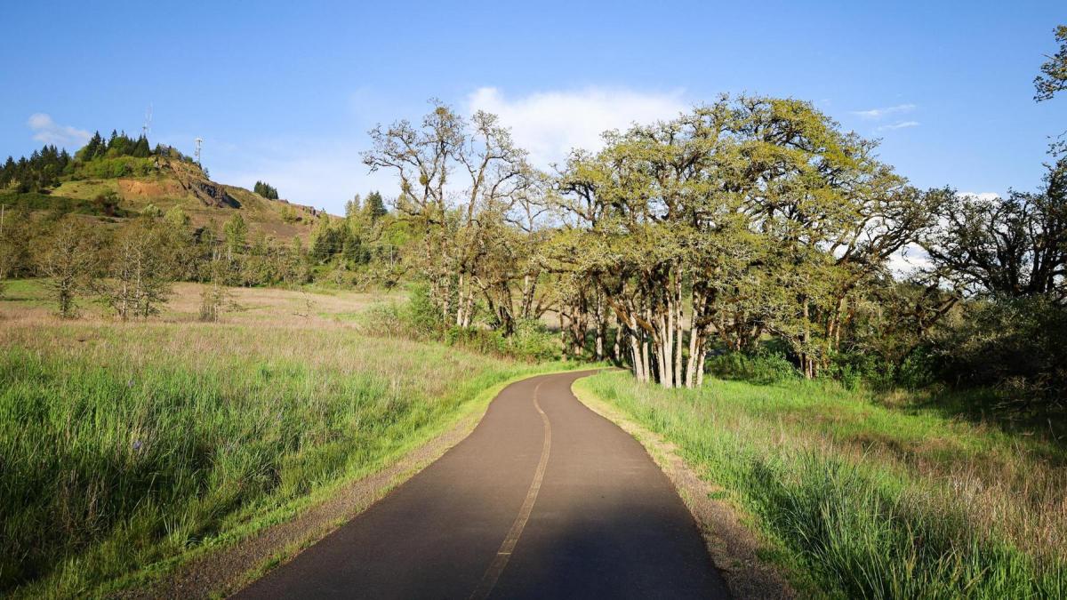 A two-lane paved multi-use path runs through Dorris Ranch and a grassy area with trees