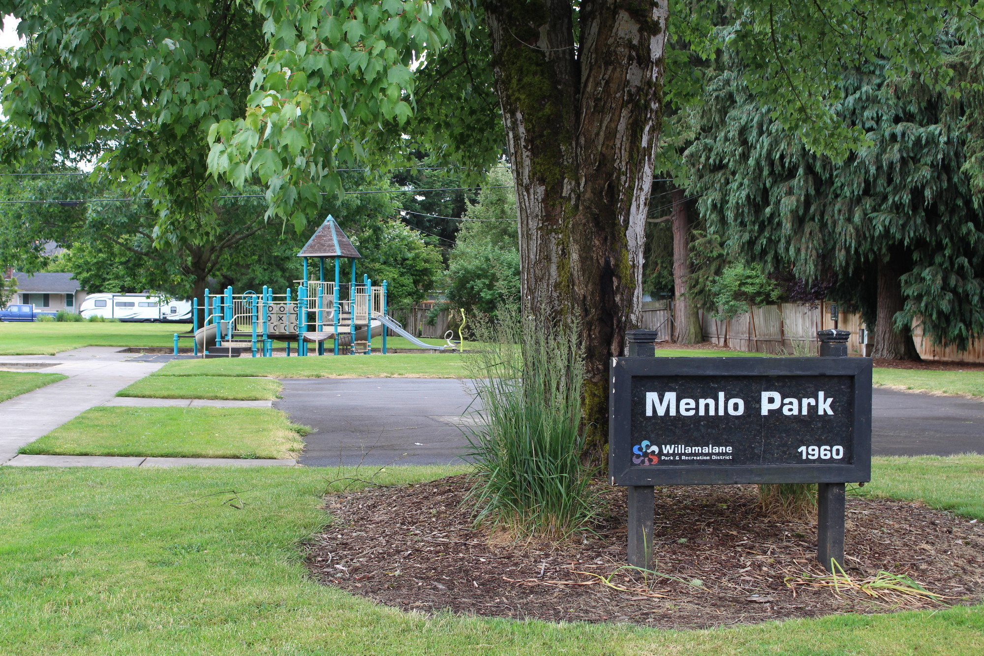 playground and basketball court with a park sign reading "Menlo Park"