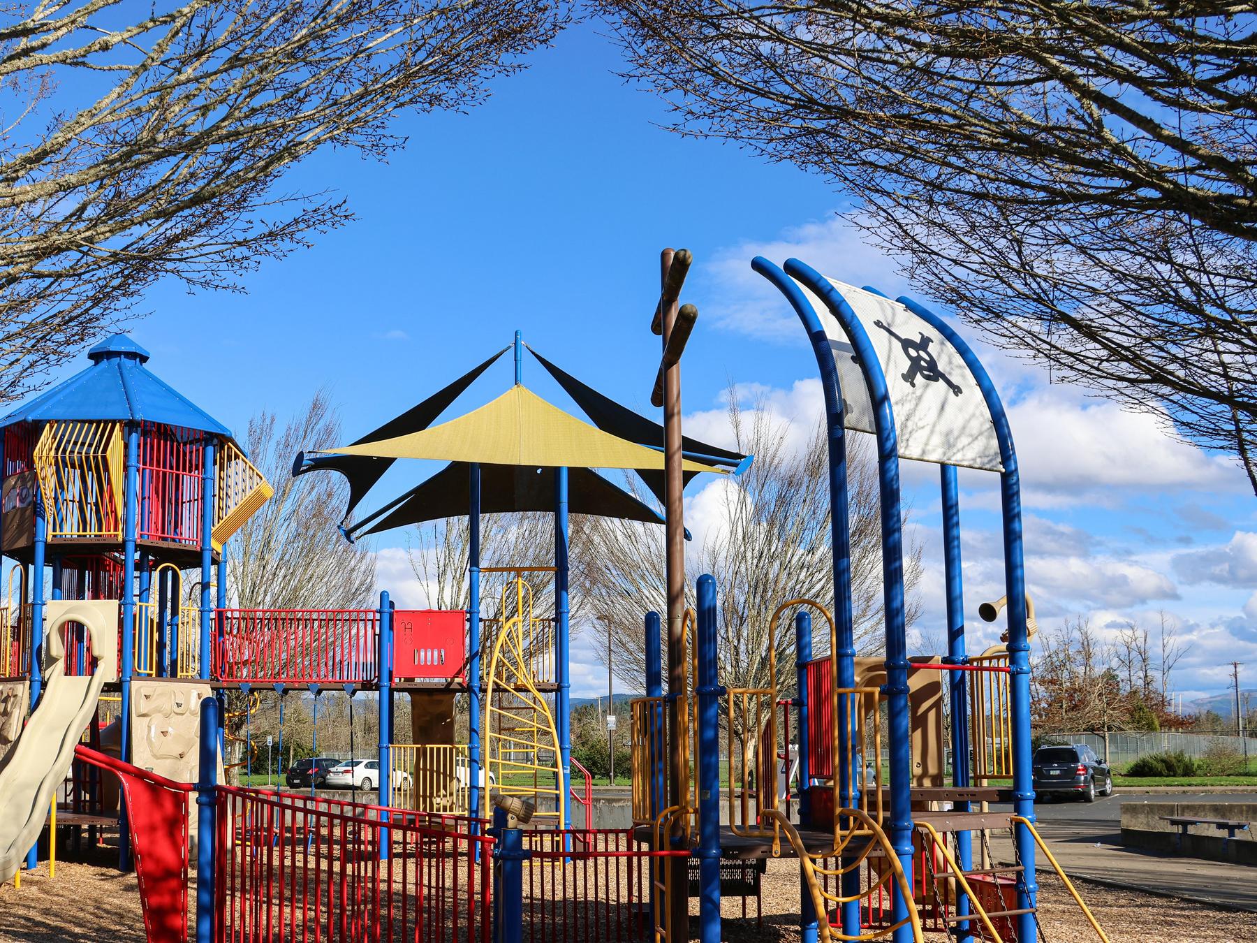 A large colorful play structure at Lively Park on a sunny day