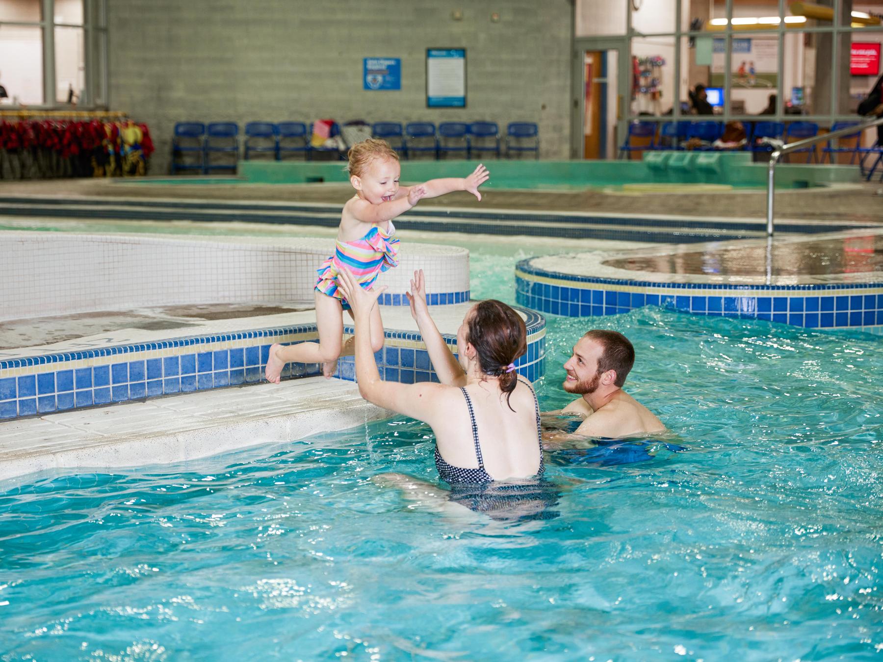 Parents catch child practicing jumping into the pool at Splash