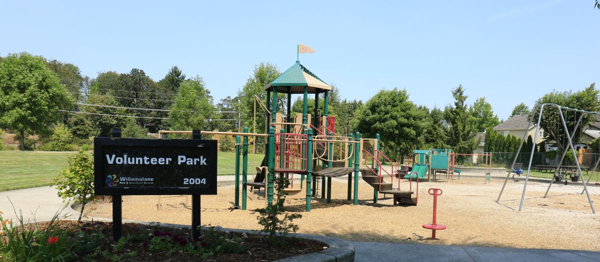 Volunteer Park sign and two play structures
