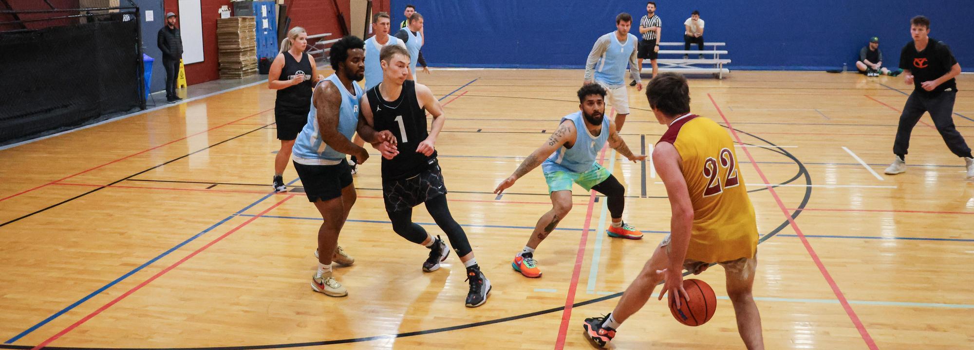 Group of people play indoor basketball at Bob Keefer Center