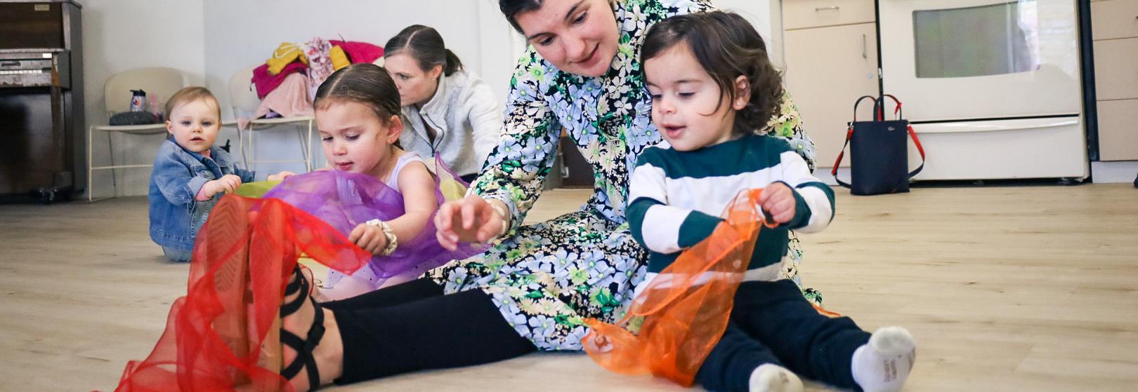 toddlers play in class with adults