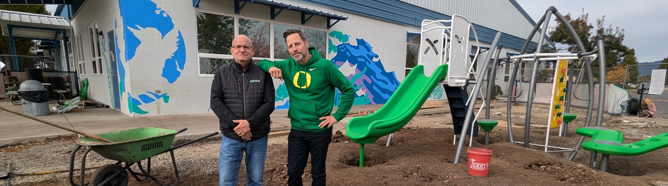 Partner stands with Willamalane Executive Director near preschool construction