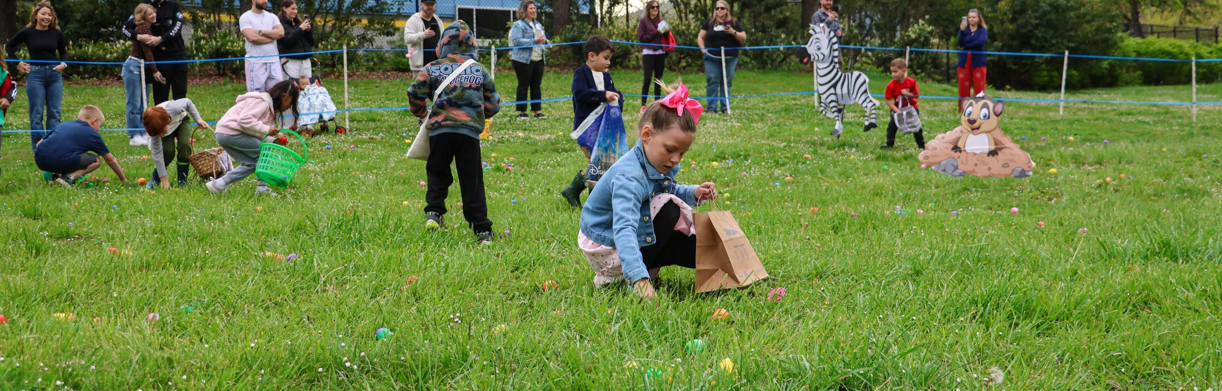 Kids pickup eggs in outdoor hunt