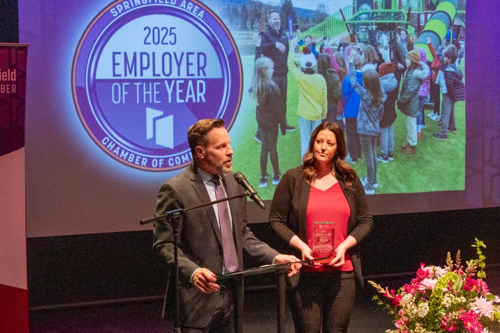 Willamalane accepts an employer of the year award on stage