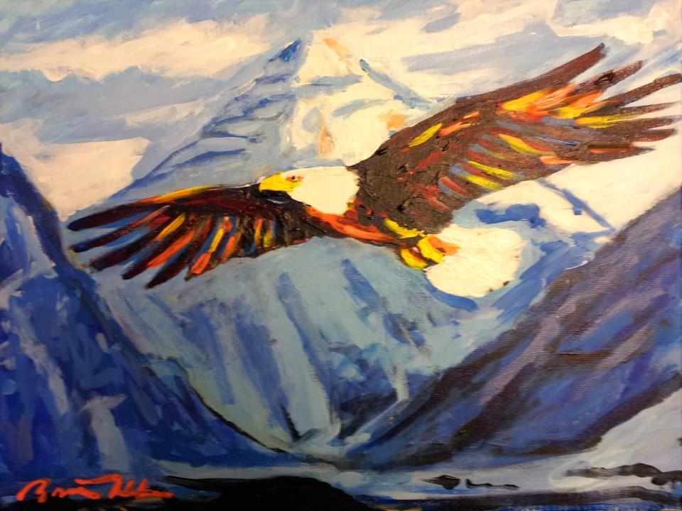 Painted eagle flying in front of a mountain scene.
