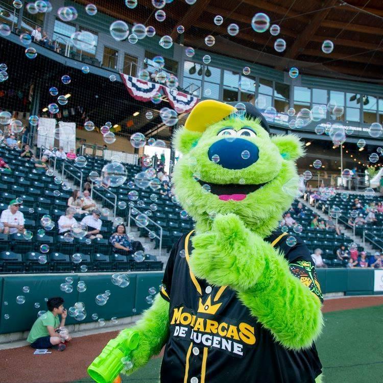 Sluggo points to camera through bubbles at a baseball game