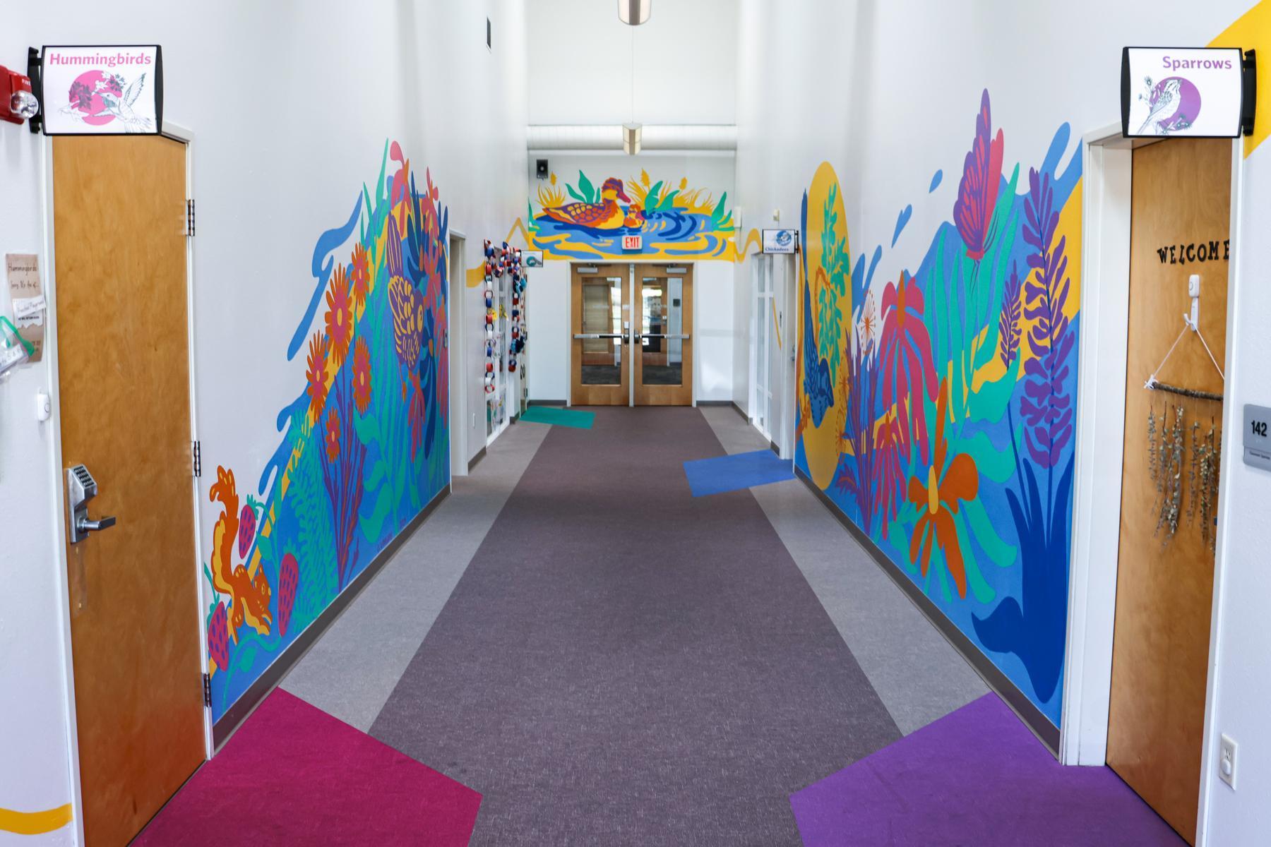 The preschool hallway features bright colors and an inviting mural