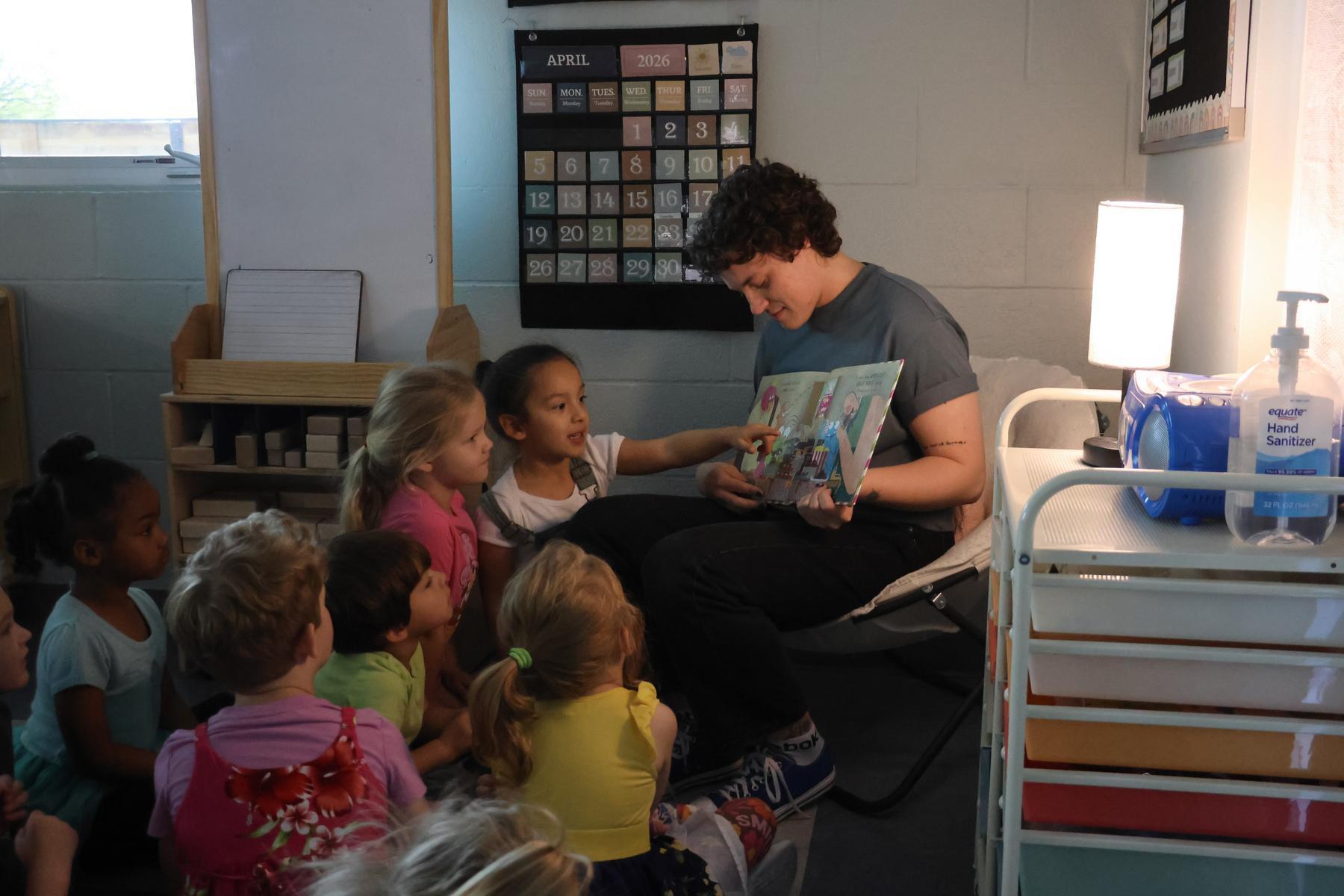 Preschoolers participate as teacher reads a book aloud