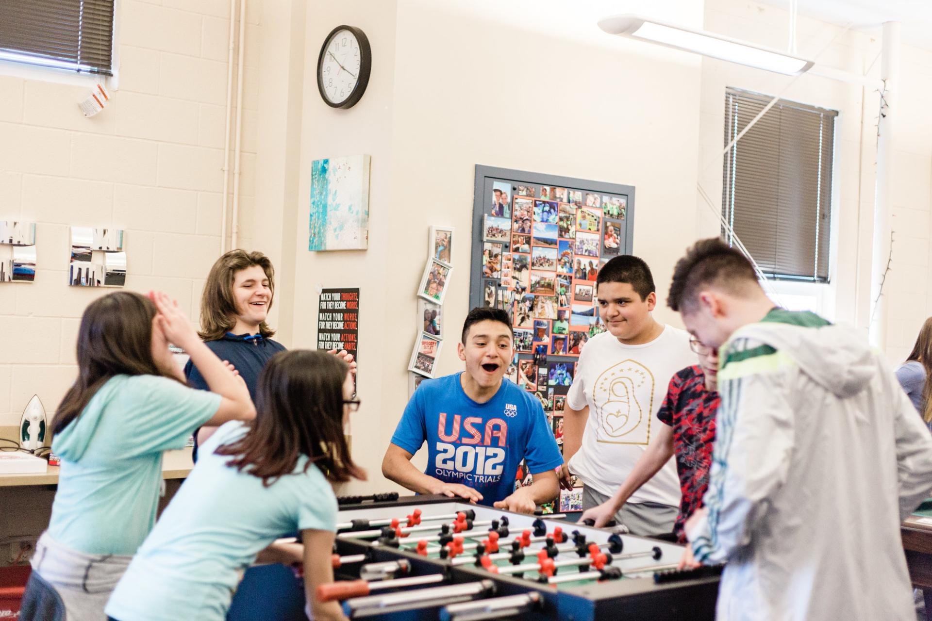 Two50 kids playing foosball