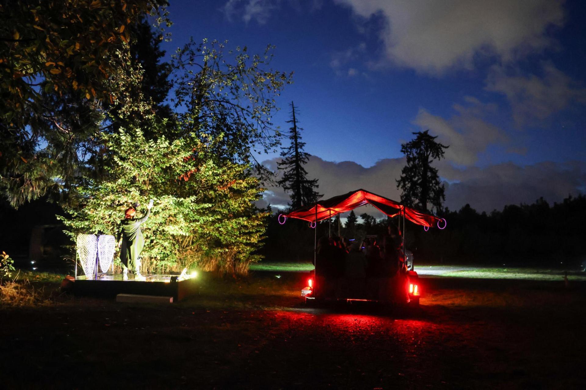 hayride trailer from behind pulling up to a performer along the hayride route