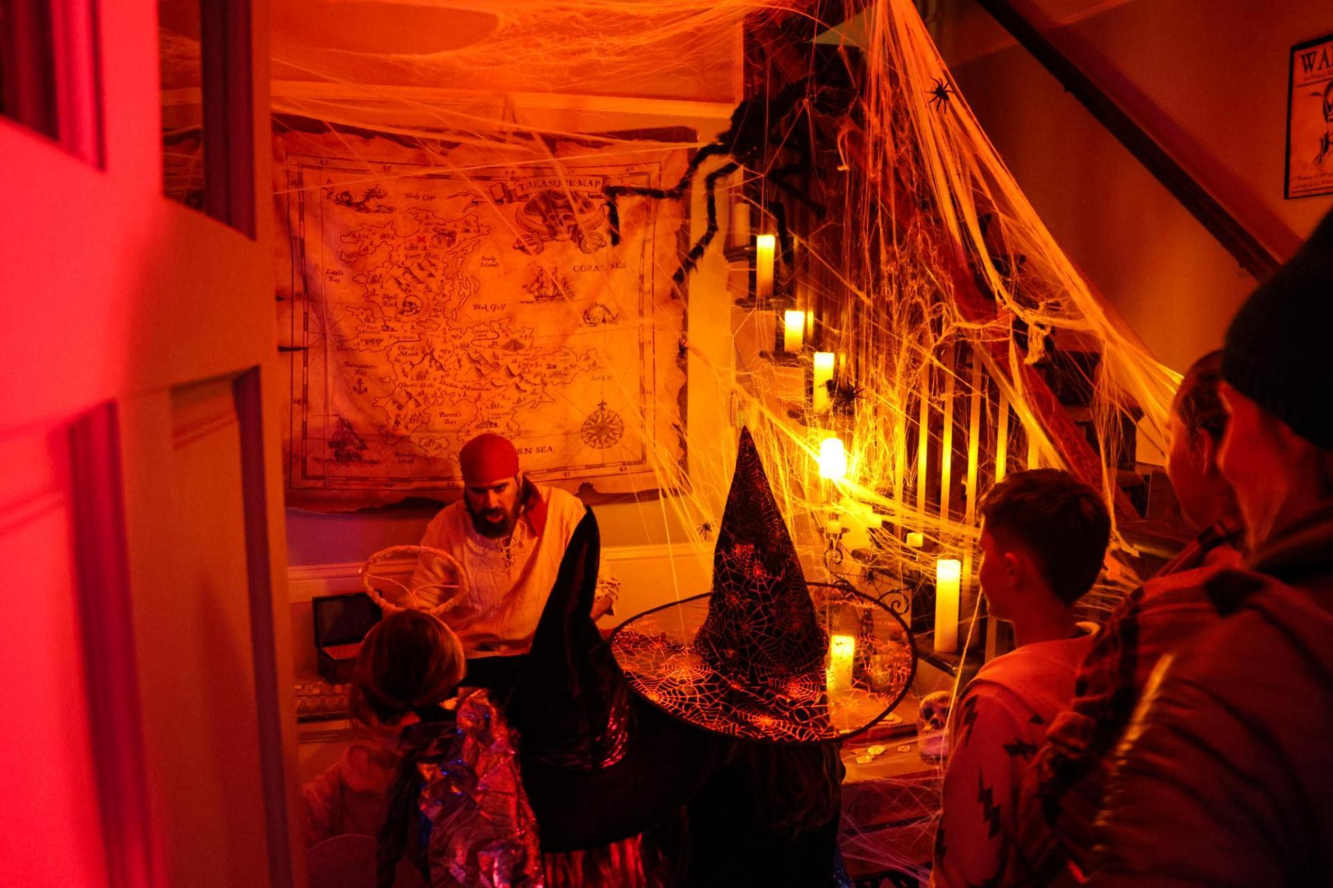 a room lit with red light and decorated with spider webs