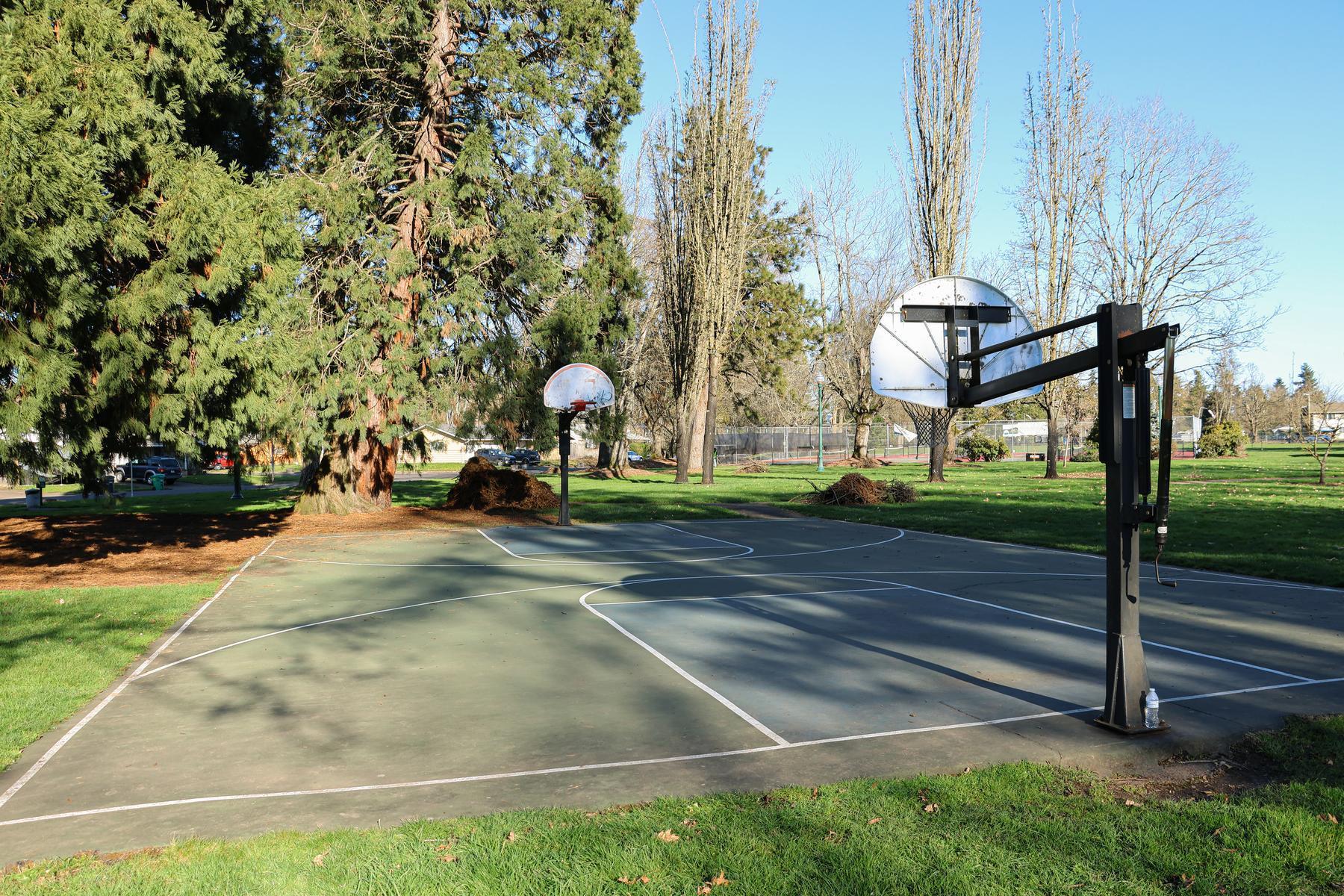Two adjustable basketball hoops at Meadow Park's outdoor court