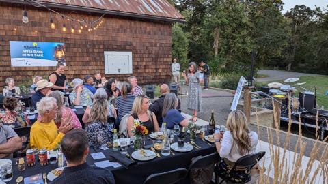 people enjoy dinner outside at Dorris Ranch event